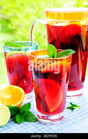 Refreshing fruit punch beverage in pitcher and glasses Stock Photo