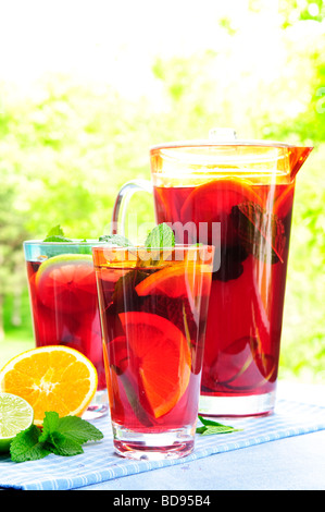 Refreshing fruit punch beverage in pitcher and glasses Stock Photo