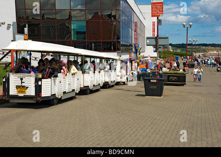 People tourists visitors riding on the land train on Bridlington promenade in summer East Yorkshire England UK United Kingdom GB Great Britain Stock Photo