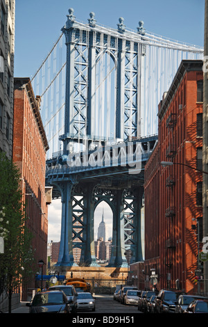 The west pylon of the Manhattan Bridge viewed from Dumbo, Brooklyn, New York.  Empire State Building visible. Stock Photo