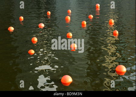 Orange Balloons floating in the Singapore River Stock Photo