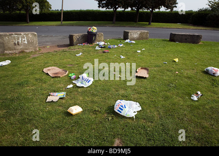 Rubbish along Otterspool Promenade has been blown around an overfull bin that has not been emptied for some time Stock Photo