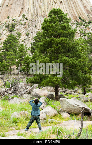 tourist looking up at Devils Tower National Monument in Wyoming Stock Photo