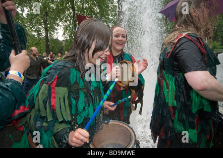 The Pagan Pride Parade in the Beltane Bash celebrations and dance around the fountain in Russell Square and drummers get wet Stock Photo