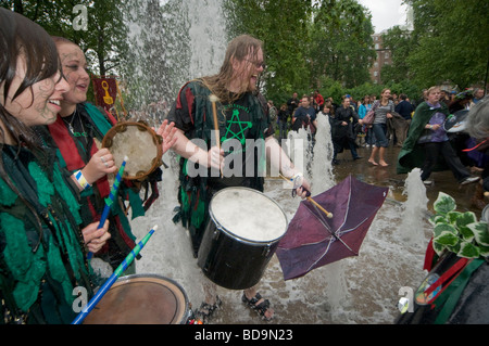 The Pagan Pride Parade in the Beltane Bash celebrations and dance around the fountain in Russell Square and drummers get wet Stock Photo