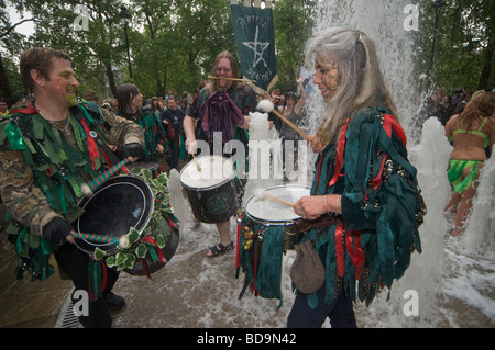 The Pagan Pride Parade in the Beltane Bash celebrations and dance around the fountain in Russell Square and drummers get wet Stock Photo