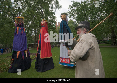 Giants and a bagpiper at Pagan Pride Parade in London, part of the Beltane Bash celebrations Stock Photo