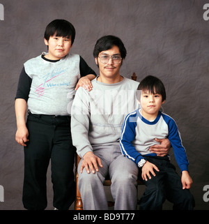 Color studio portrait of Inuit father and two children in a photography studio in Iqaluit Nunavut Canada Stock Photo