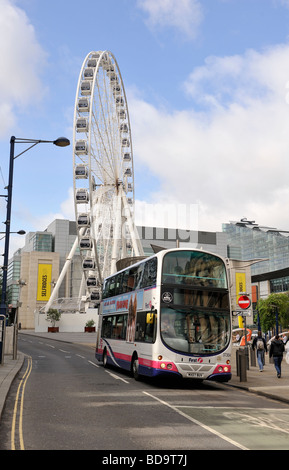 The Manchester Eye looking over a local bus Stock Photo