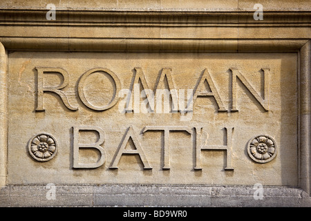 Stone carved sign at the Roman Baths with the Bath Abbey in the ...
