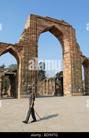 Guard patrolling at the Qutb Minar complex, Delhi, India Stock Photo