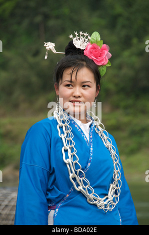 Pretty Miao girl with rose in hair at Drum Festival Shidong Guizhou Province China Stock Photo