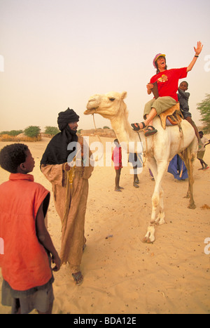 Elk Camel Ride Tourist on a camel ride in front of the Great Pyramid of Giza, the ...