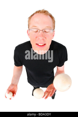 young man juggling with three balls Stock Photo