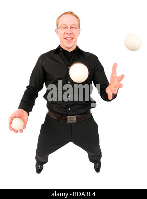 young man juggling with three balls Stock Photo