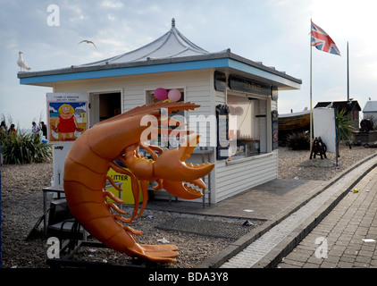 Giant plastic prawn outside shellfish kiosk on Brighton seafront beach UK Stock Photo