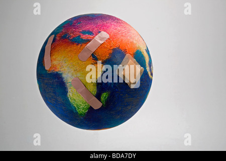 Still shot of a world globe with band aids on Africa and Asia Stock Photo