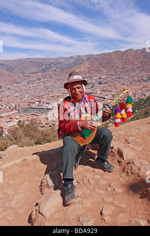 native man playing the guitar at a viewpoint, Cuzco, Peru, South America Stock Photo