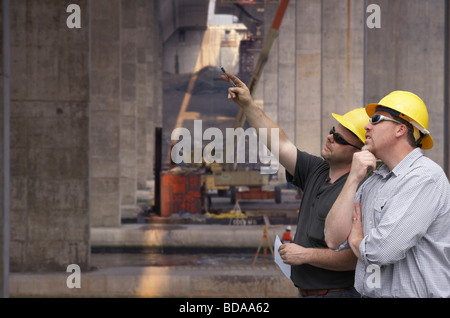 Construction engineer and foreman on a bridge building job site Stock Photo