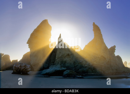 Sea stacks at Bandon Beach with fog and sun rays Oregon Stock Photo