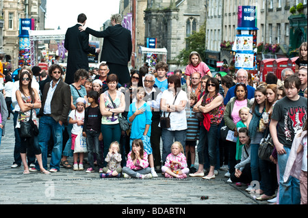 Crowds watch street performers in the Royal Mile during the Edinburgh Fringe Festival August 2009 Stock Photo
