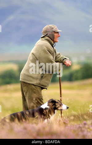 Highland shepherd with his Border Collie Dog at Scottish sheepdog Trials Stock Photo