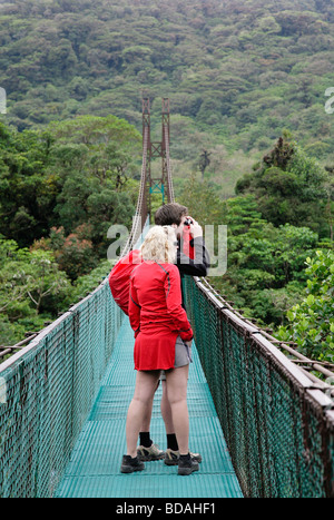 costa rica monteverde cloud forest national park tropical rain forest hikers along elevated sky walk central latin america Stock Photo