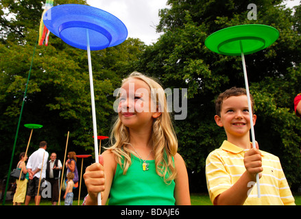 Youngsters having a go at plate spinning at Chawton Village Fete, Chawton near Alton, Hampshire, UK. 08.08.2009. Stock Photo
