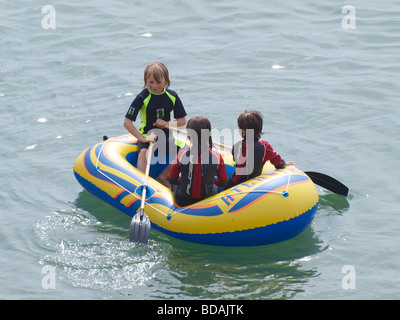 Children playing in a small boat Stock Photo