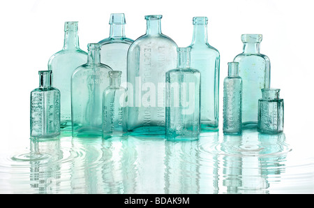 Antique bottles sitting in water Stock Photo