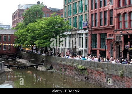 People relaxing outside restaurants and bars Canal Street Manchester England Stock Photo