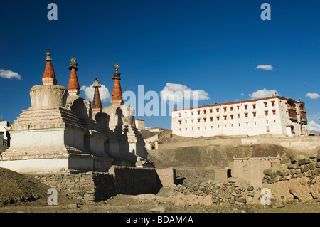 Chortens with a monastery in the background, Stok Monastery, Ladakh, Jammu and Kashmir, India Stock Photo