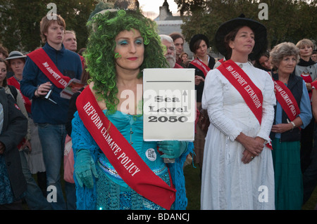 Climate Rush protest on 100th anniversary of Suffragette rush on Parliament. Mermaid and others with red sashes Stock Photo