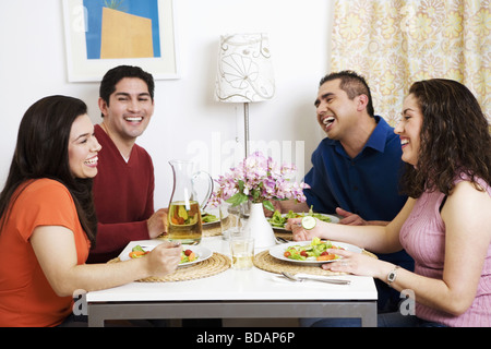 Two couples having their breakfast and smiling Stock Photo