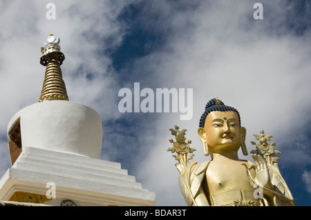 Low angle view of statue of Buddha near a chorten, Likir Monastery, Ladakh, Jammu and Kashmir, India Stock Photo