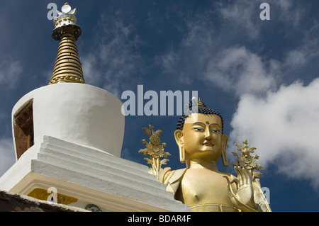 Low angle view of statue of Buddha near a chorten, Likir Monastery, Ladakh, Jammu and Kashmir, India Stock Photo