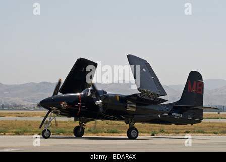 A Grumman Tigercat taxis on the runway after flying at an air show, the wings have started to fold up. Stock Photo