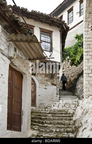 A typical narrow alleyway with overhanging ottoman period houses in the Mangalemi district of Berat in central Albania Stock Photo