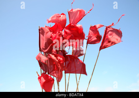 Red fishing buoy flags against a blue summer sky in a Danish harbour Stock Photo