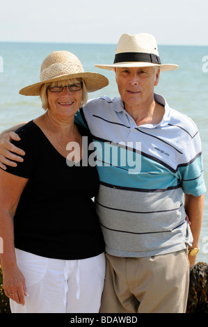 Portrait of a man and woman wearing sunhats at the seaside Stock Photo