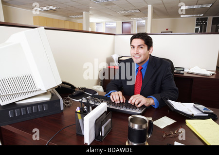 Portrait of a businessman working on a desktop PC in an office Stock Photo