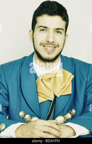 Portrait of a young man smiling in traditional clothing Stock Photo