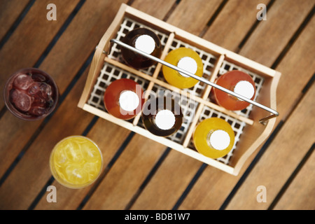 High angle view of two juice glasses and bottles in a basket Stock Photo
