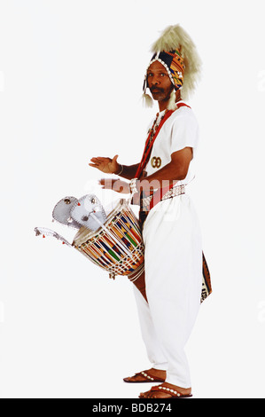 Portrait of a mid adult man playing a drum Stock Photo