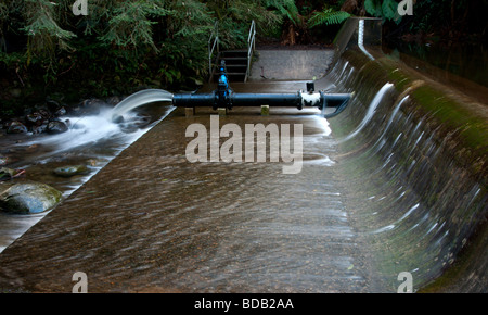 Water being released from a small weir. Stock Photo