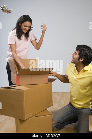 Couple relaxing with cardboard boxes Stock Photo
