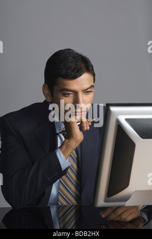 Businessman working on a desktop PC Stock Photo