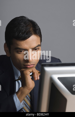 Businessman working on a desktop PC Stock Photo
