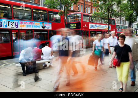 Shoppers on Oxford Street in Central London. This is a busy shopping area for all the main high street chain stores. Stock Photo