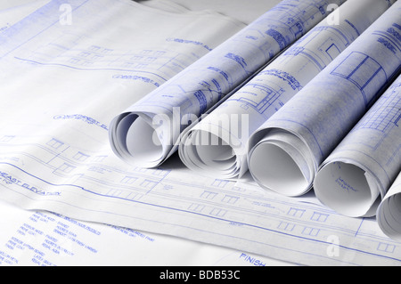 Rolls of architectural blueprints on a drawing table Stock Photo